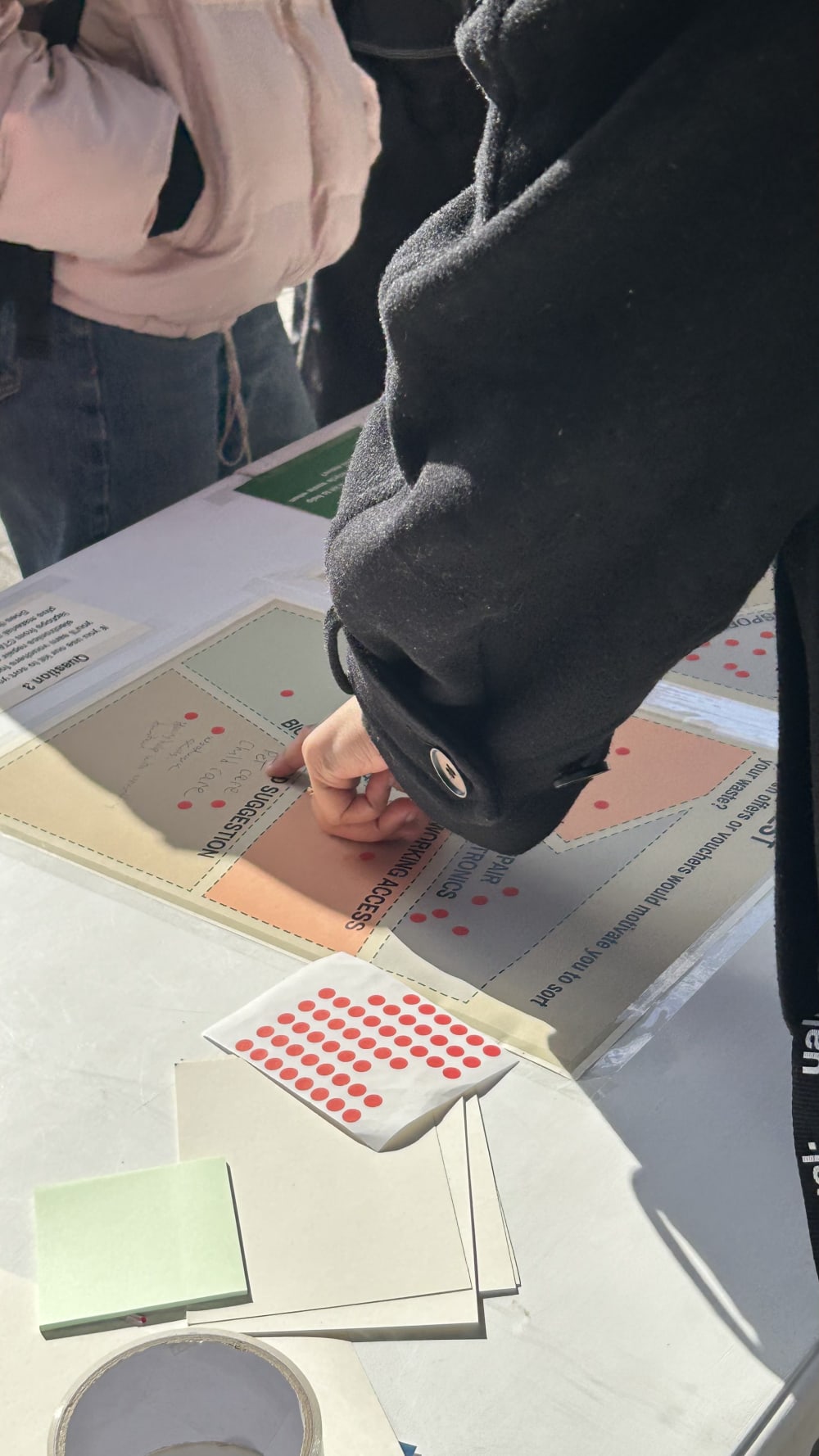 Someone pointing at a flyer on a table
