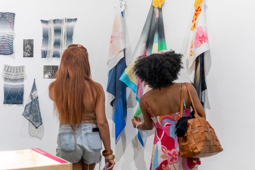 UAL students and alumni looking at the graduates' work