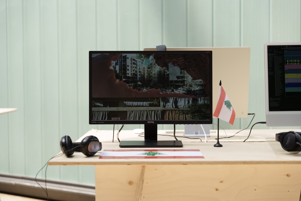 Computer showing images of Lebanon next to a Lebanese flat