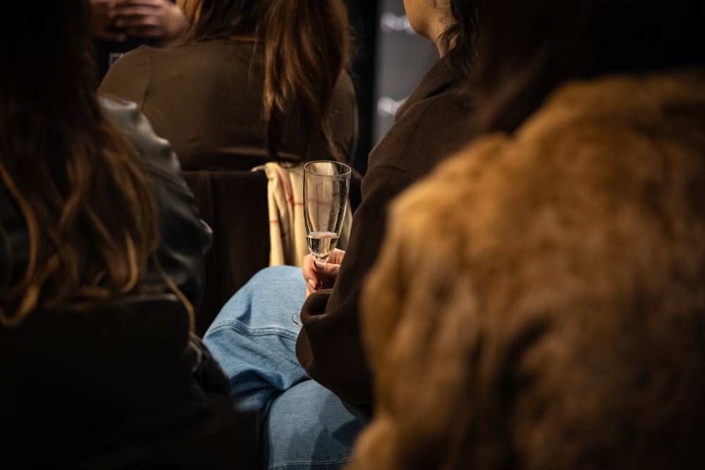 close up on a person holding a glass of wine
