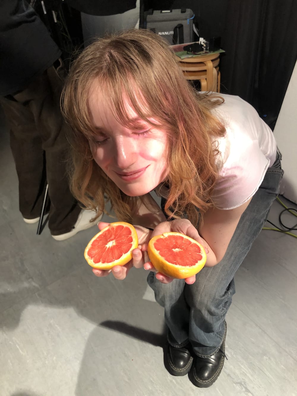 Ella holding grapefruit for film scene
