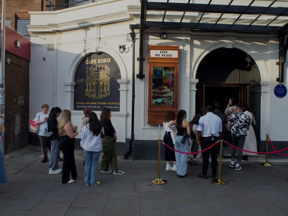 People outside entrance of building. 