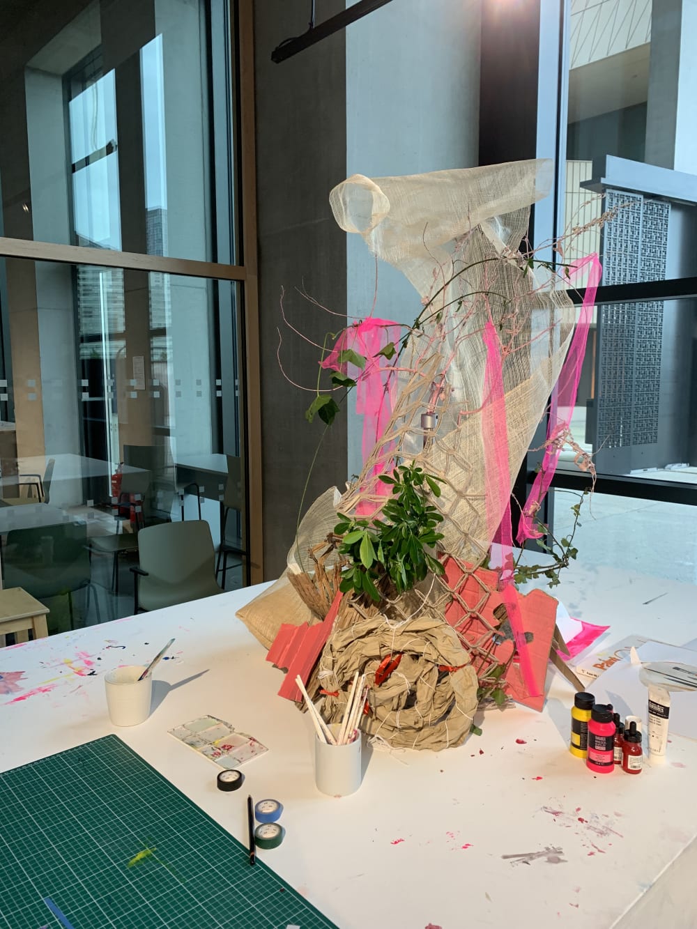 Collection of colourful materials on large table.