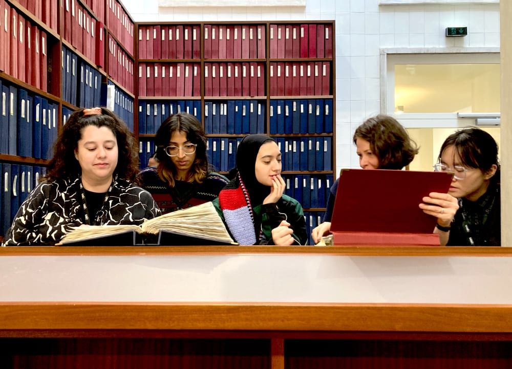 a group of people looking at books