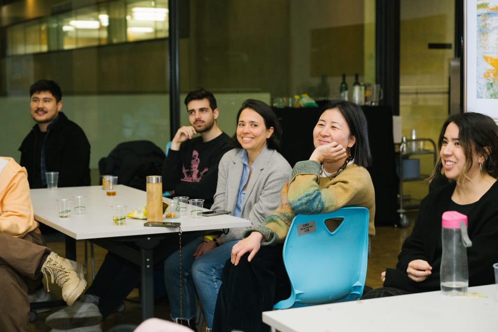 Guests sat listening and smiling during the workshop