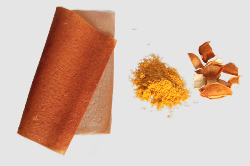 Yellow powder and dried orange skins with a sample of material