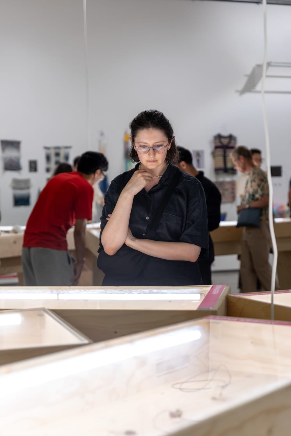 UAL students and alumni looking at the graduates' work