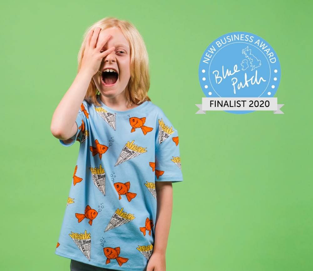 Photo of a young blonde boy against a green background