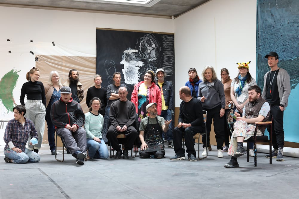 a photograph of a group of people standing in a gallery