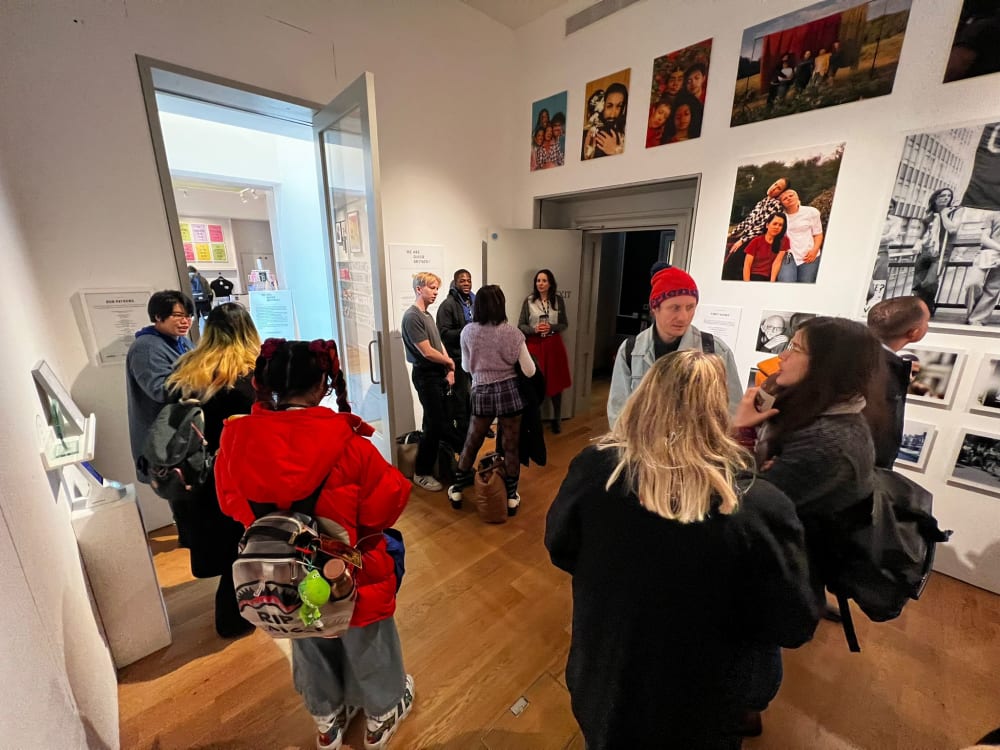 students in a gallery space looking at photographs