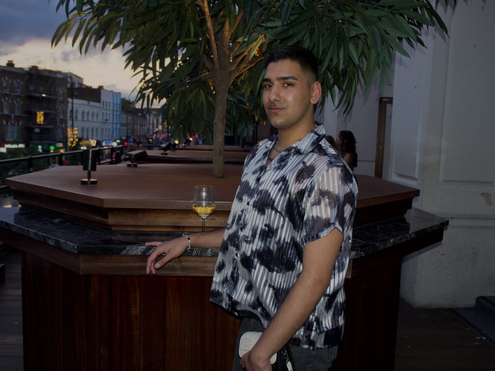 Person standing by table. 