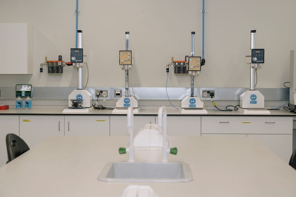 Laboratory with four machines on a table.