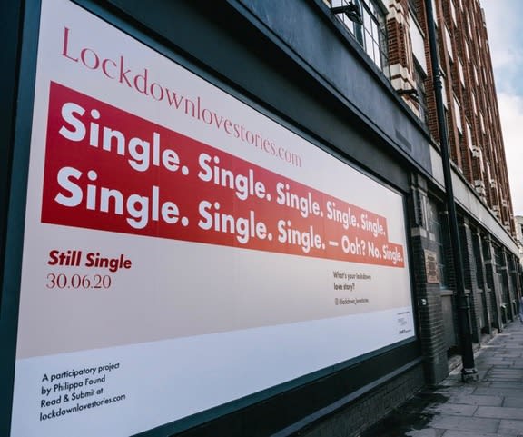 Landscape photo of a large vinyl poster that reads: 