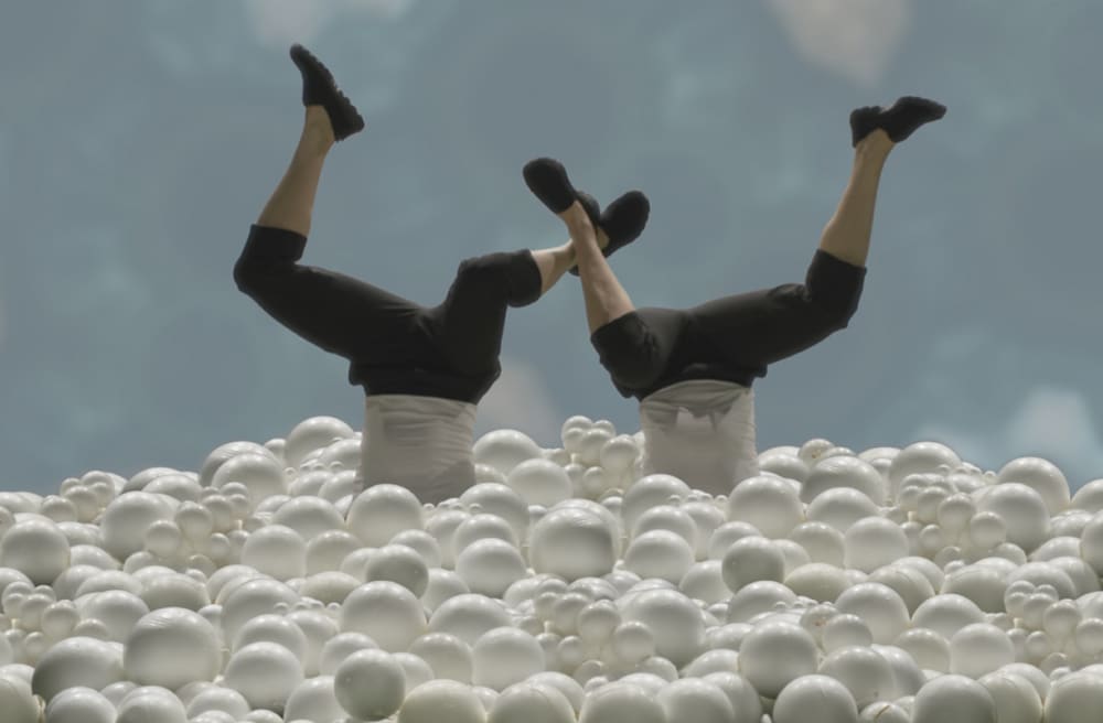Two people with their legs in the air