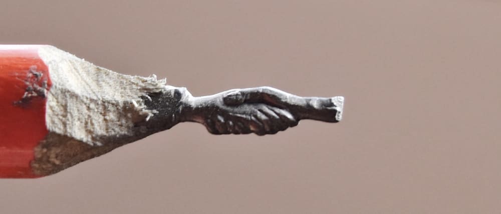 Pencil graphite shaped into hands holding onto each other.
