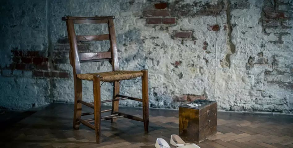 wooden upright chair with a pair of white shoes and wooden box on floor