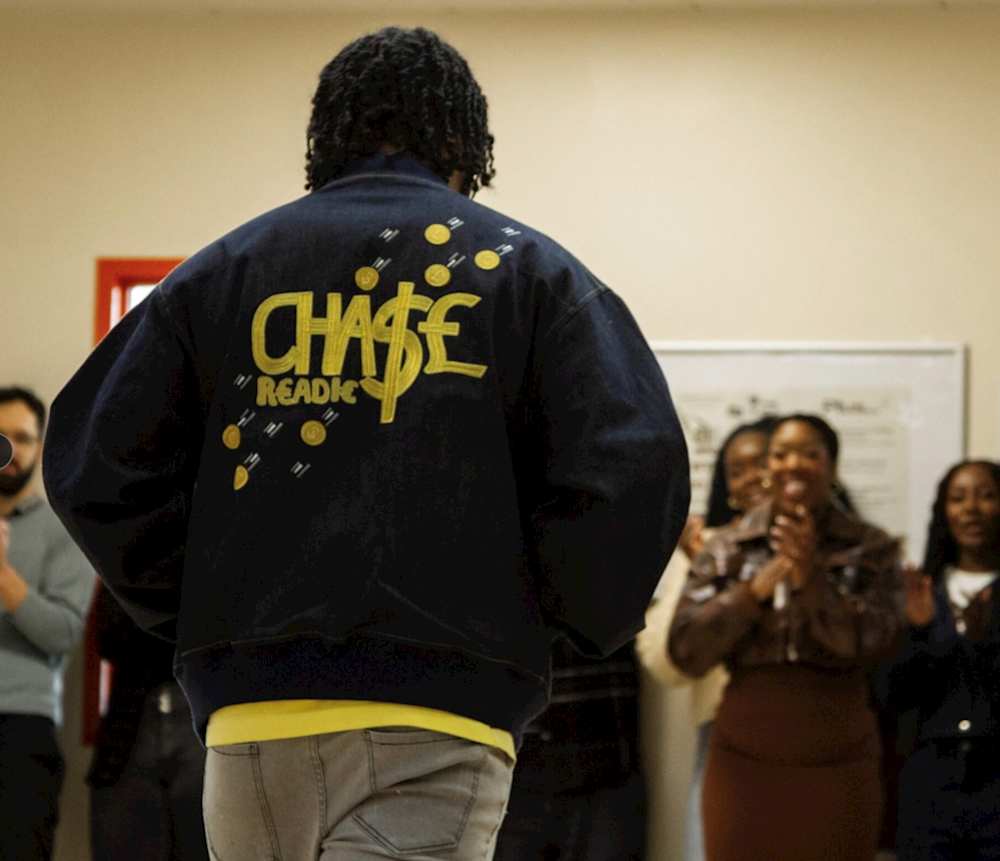 An image of a man showing of his jacket