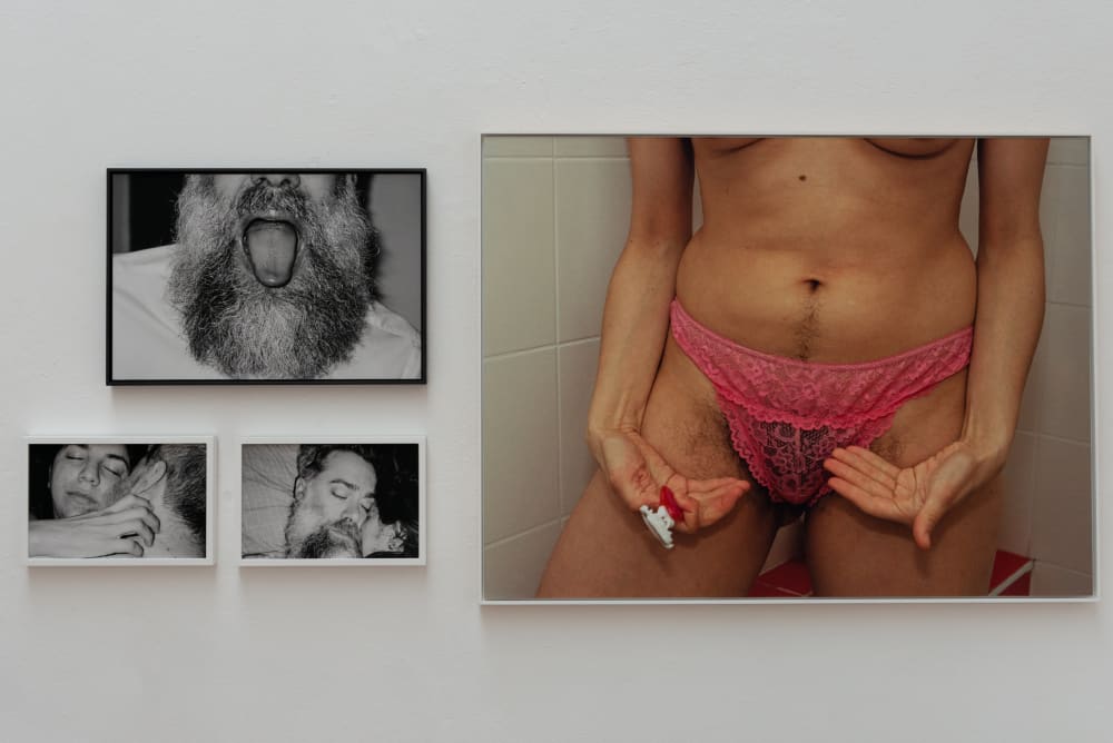 4 photographs on a wall, three in black and white and one in colour