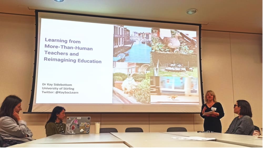 a photograph of people stood in front of a projection