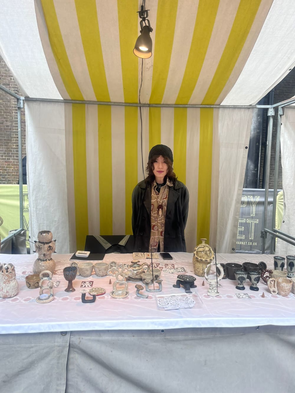 Stallholder showcasing artworks