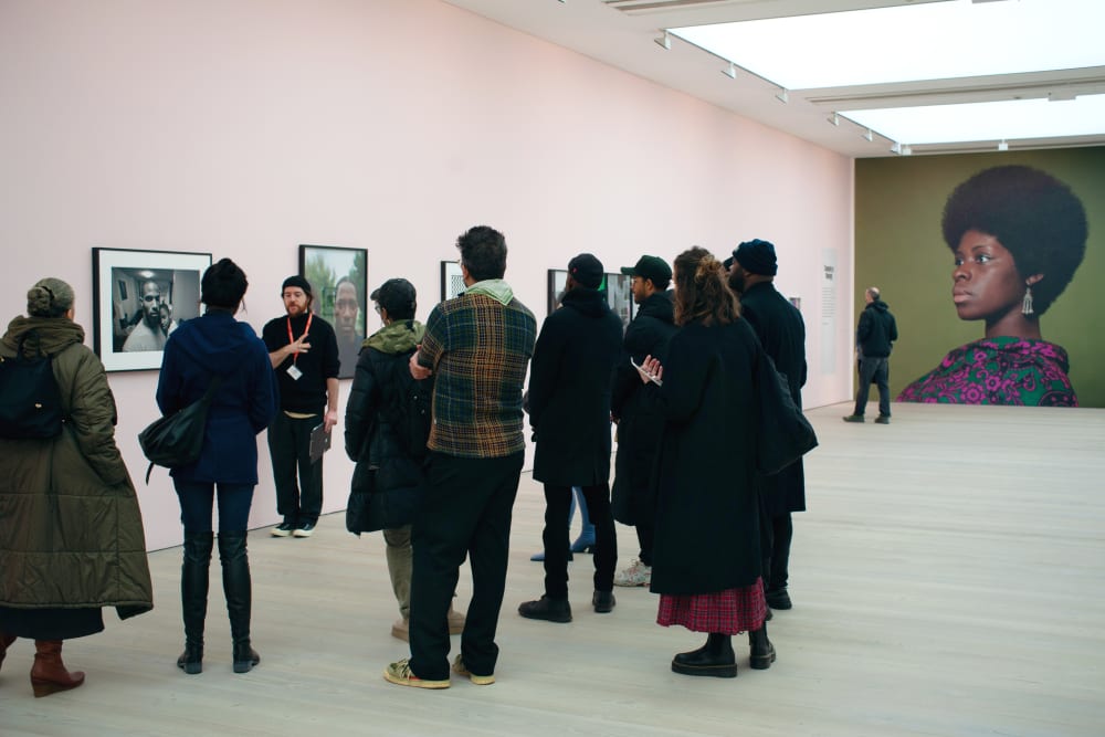 Photo of the group from behind; Karl is facing the group talking