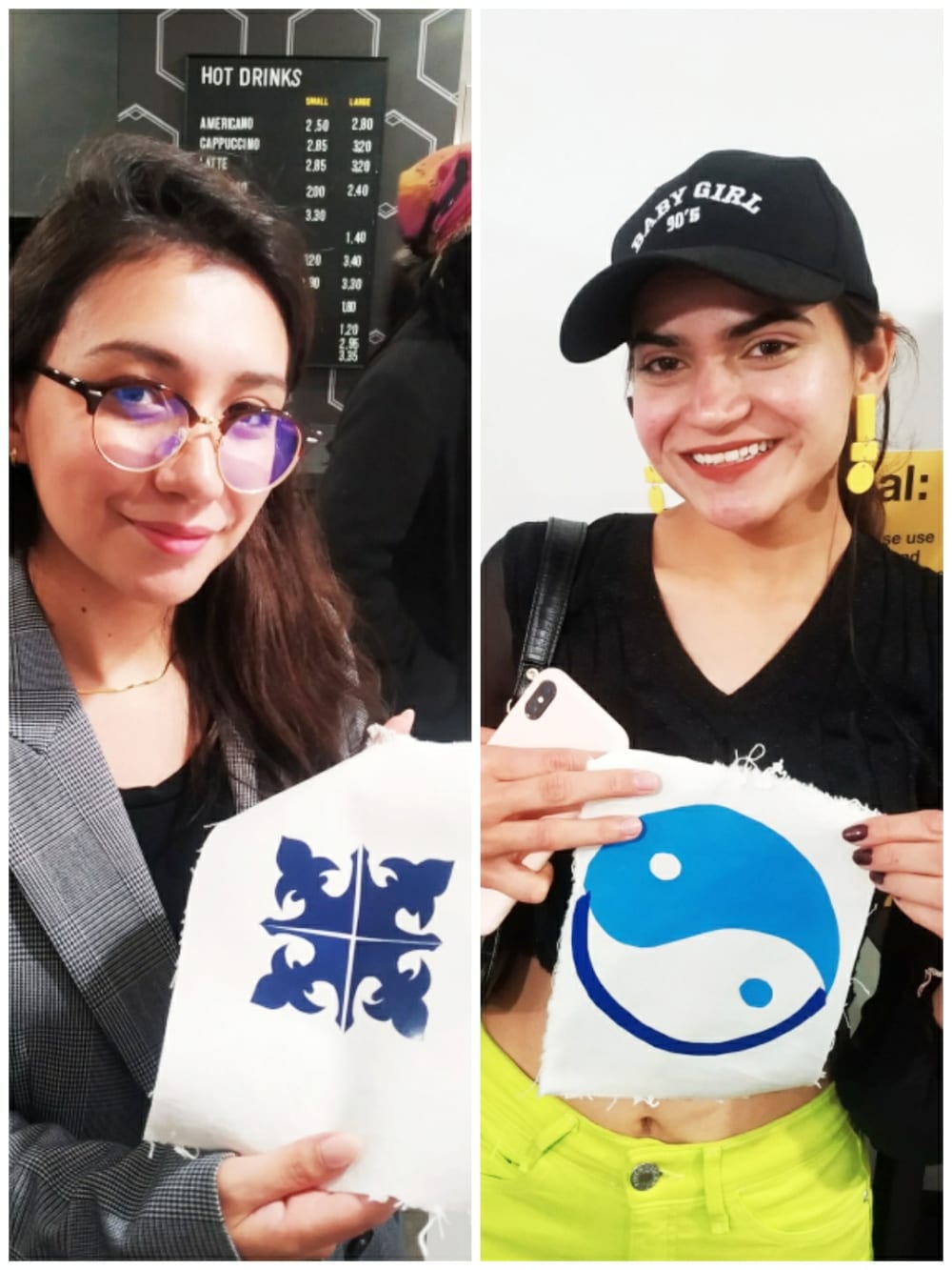 Two students holding their pieces, one is a four-cornered square design, the other a yin-yang symbol