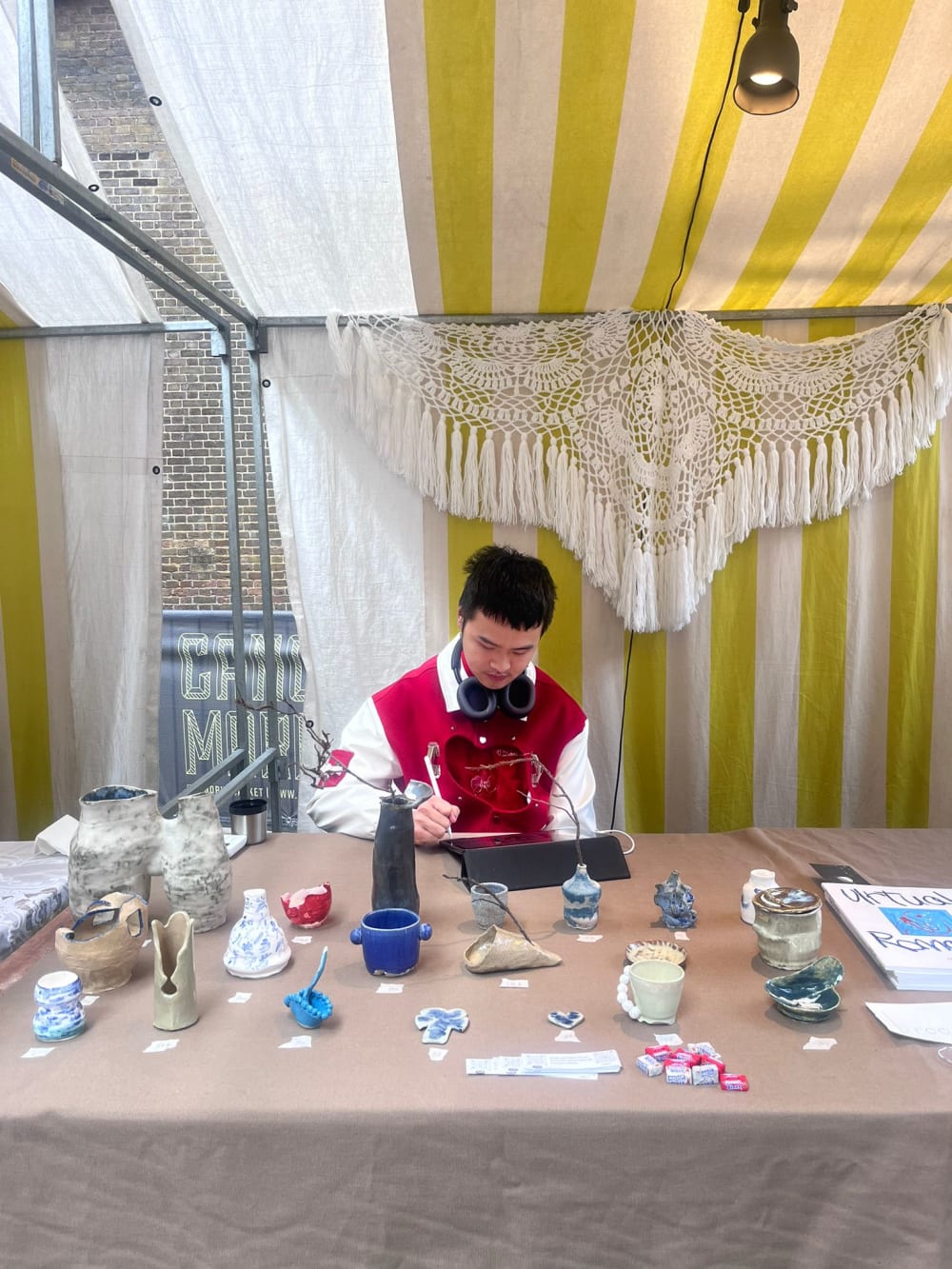 Stallholder showcasing artworks