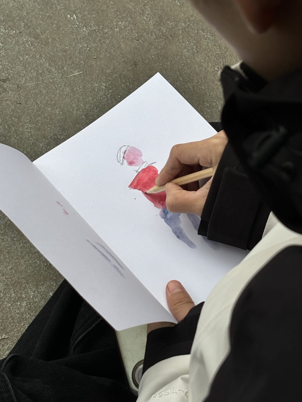 Someone drawing in a sketchbook