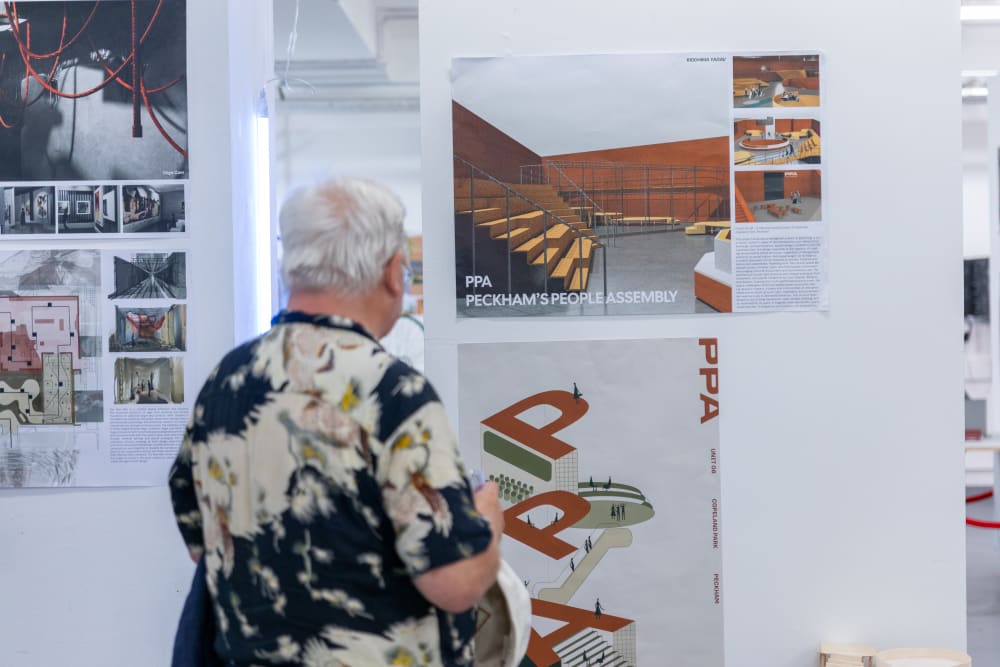 UAL students and alumni looking at the graduates' work