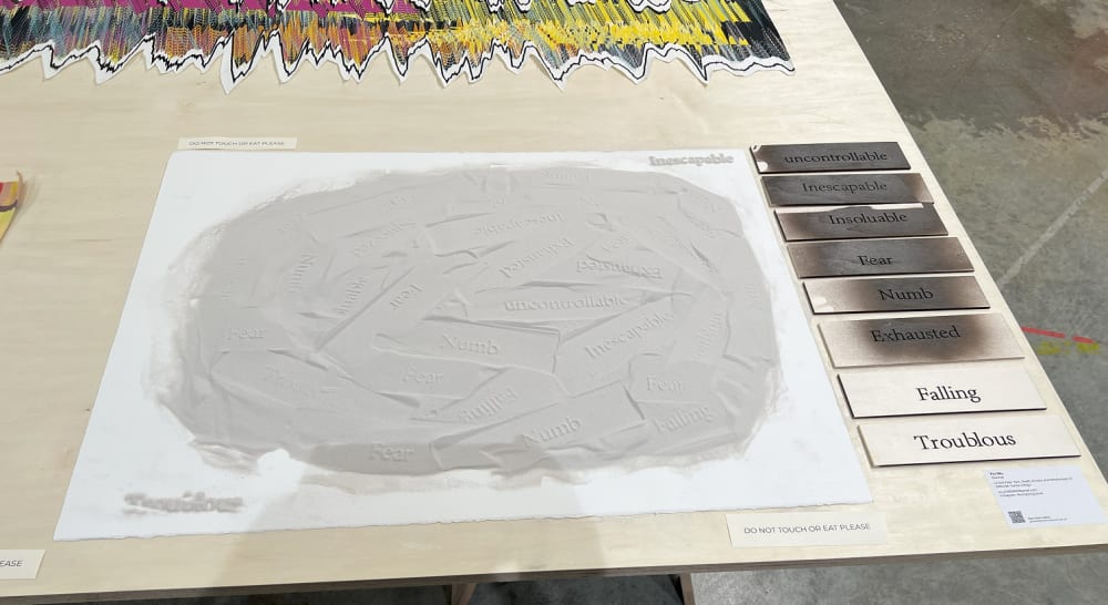 a pale grey sculpture being displayed on a table