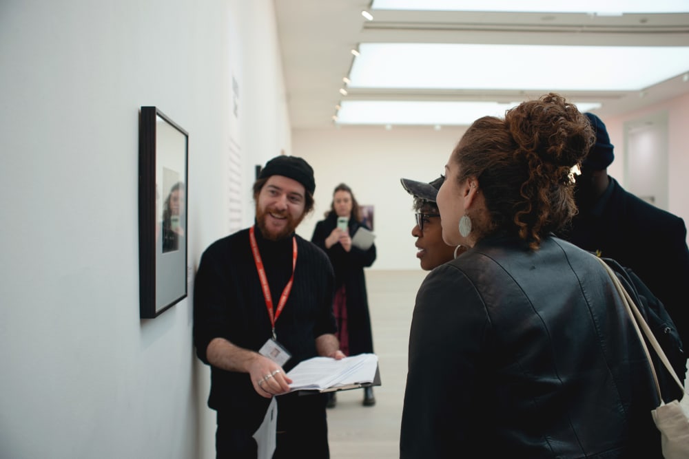Guests looking closely at one of the photos