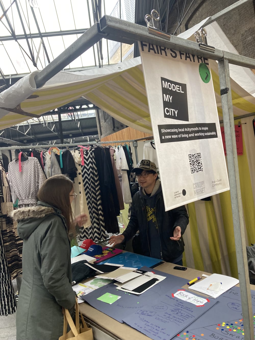 Stallholder showcasing artworks