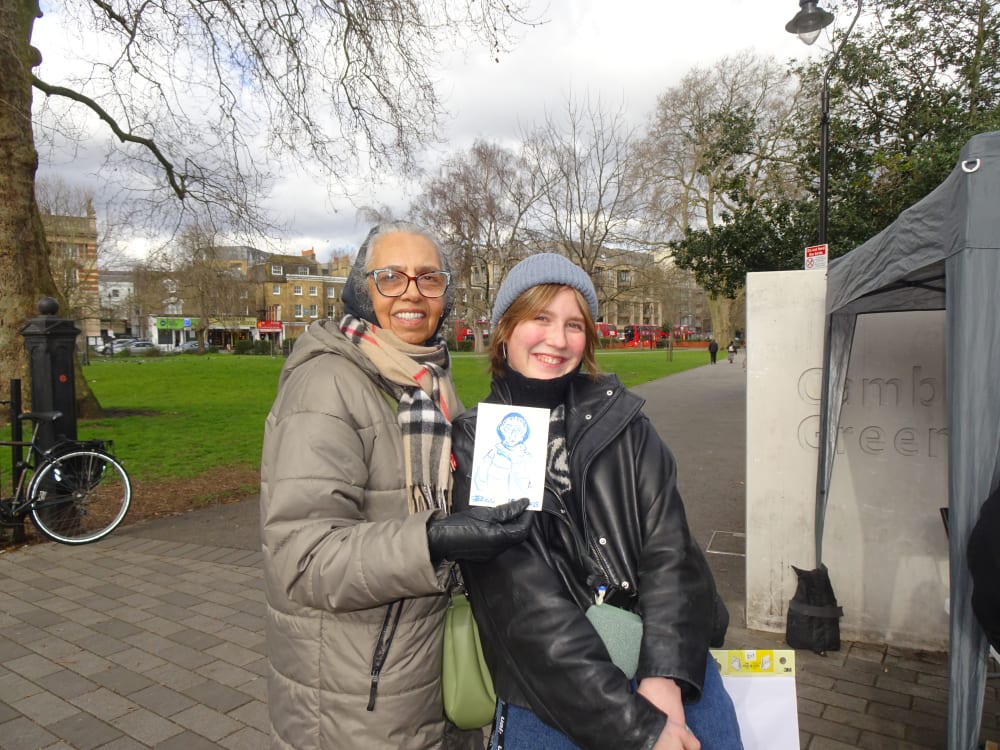Two women standing in front of a farmer's market stand