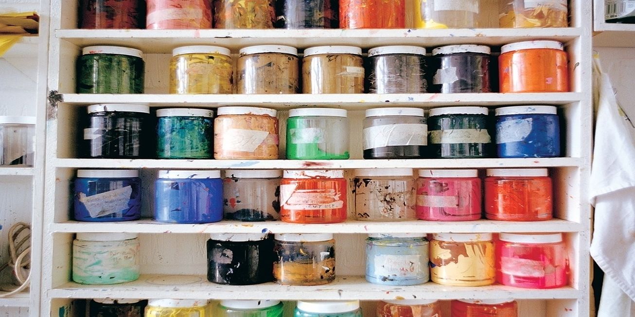 Shelves of coloured paint pots