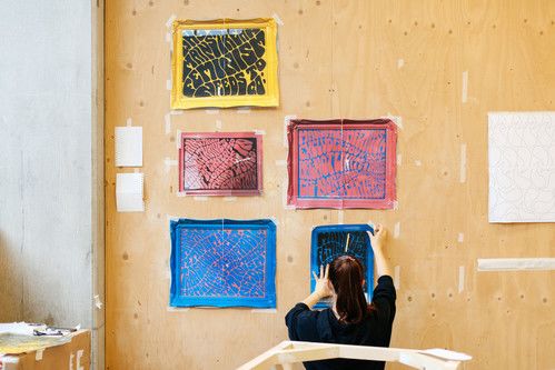 Student hanging up art