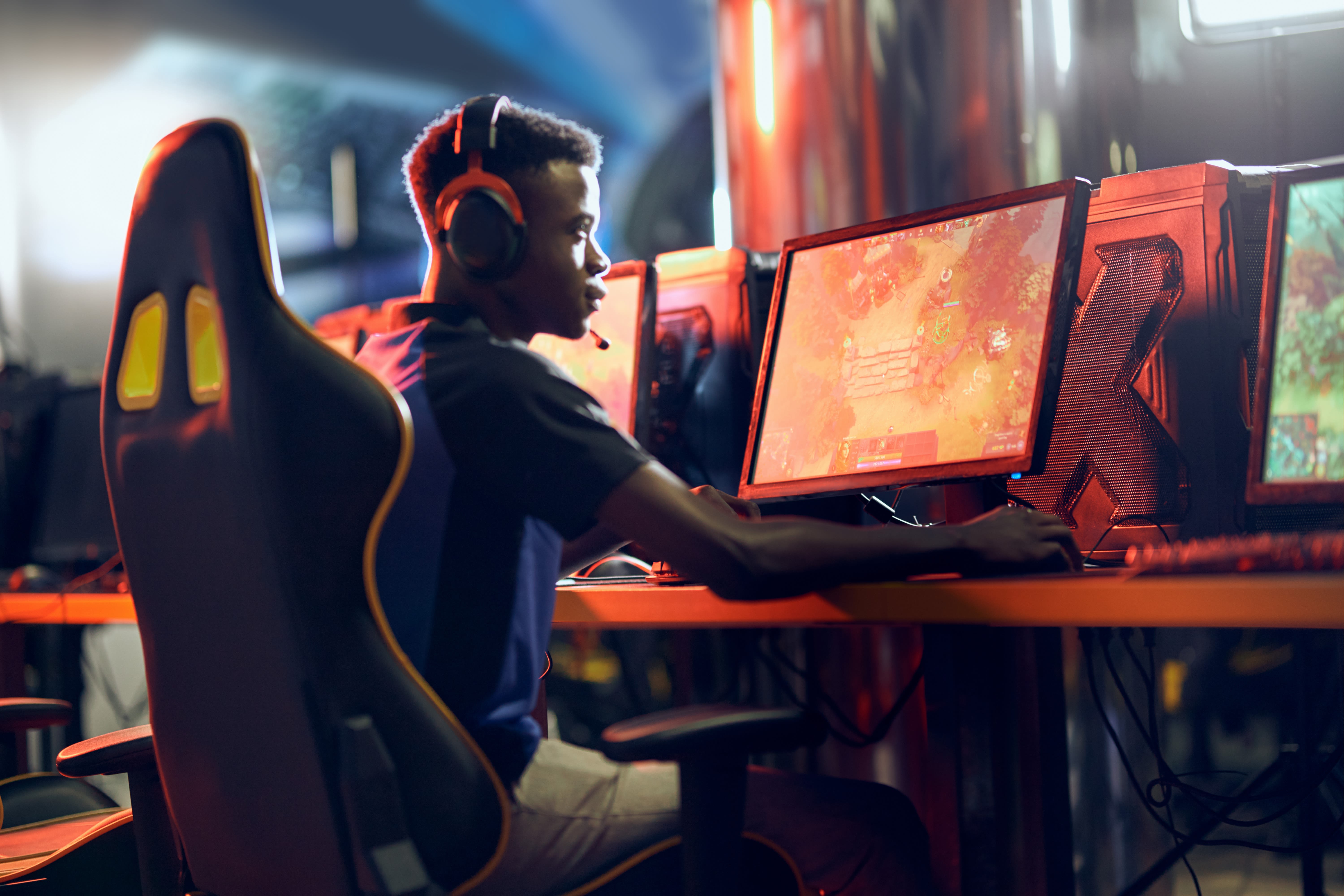 A student sat at a computer playing an esports game