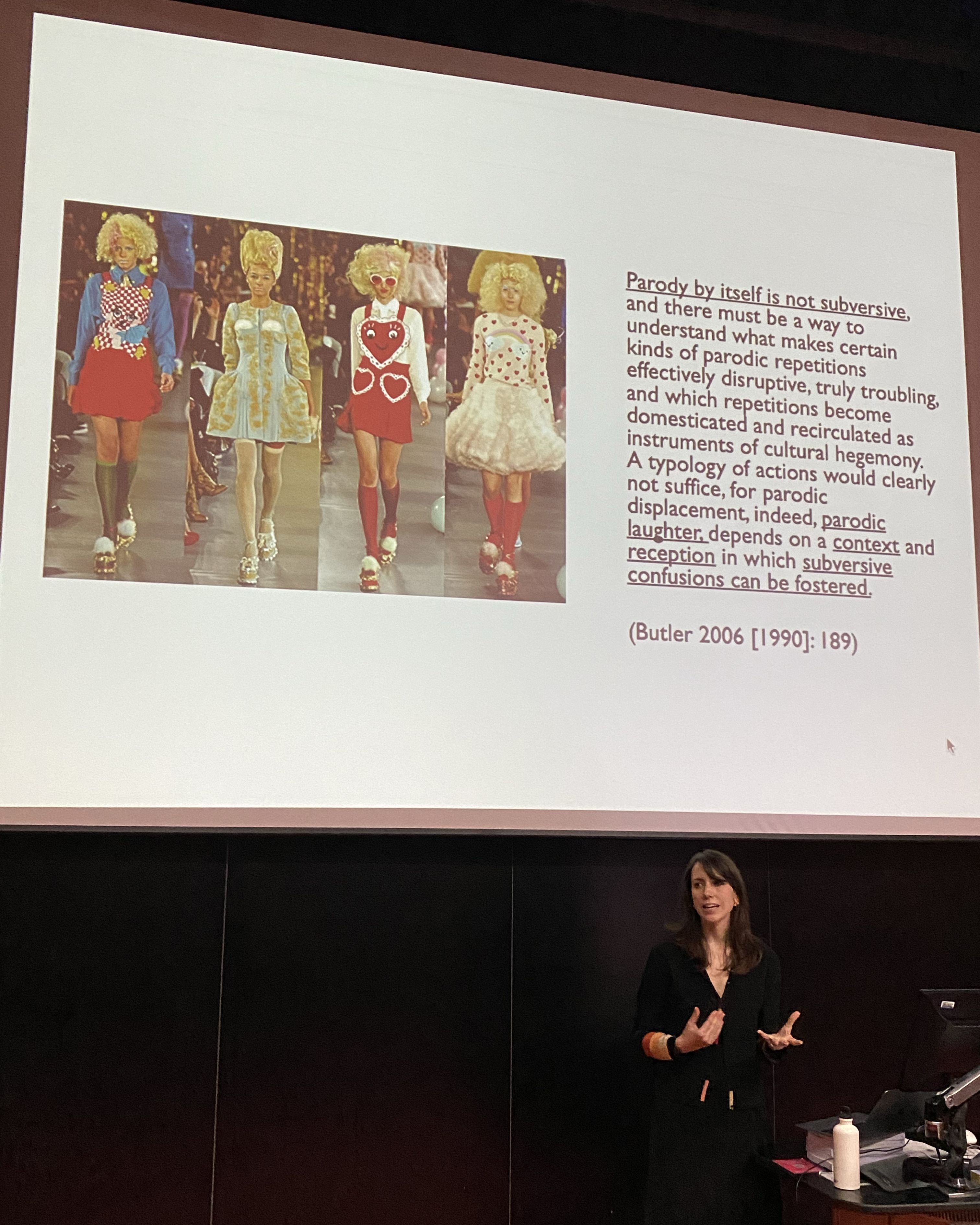 Person giving presentation with models on screen
