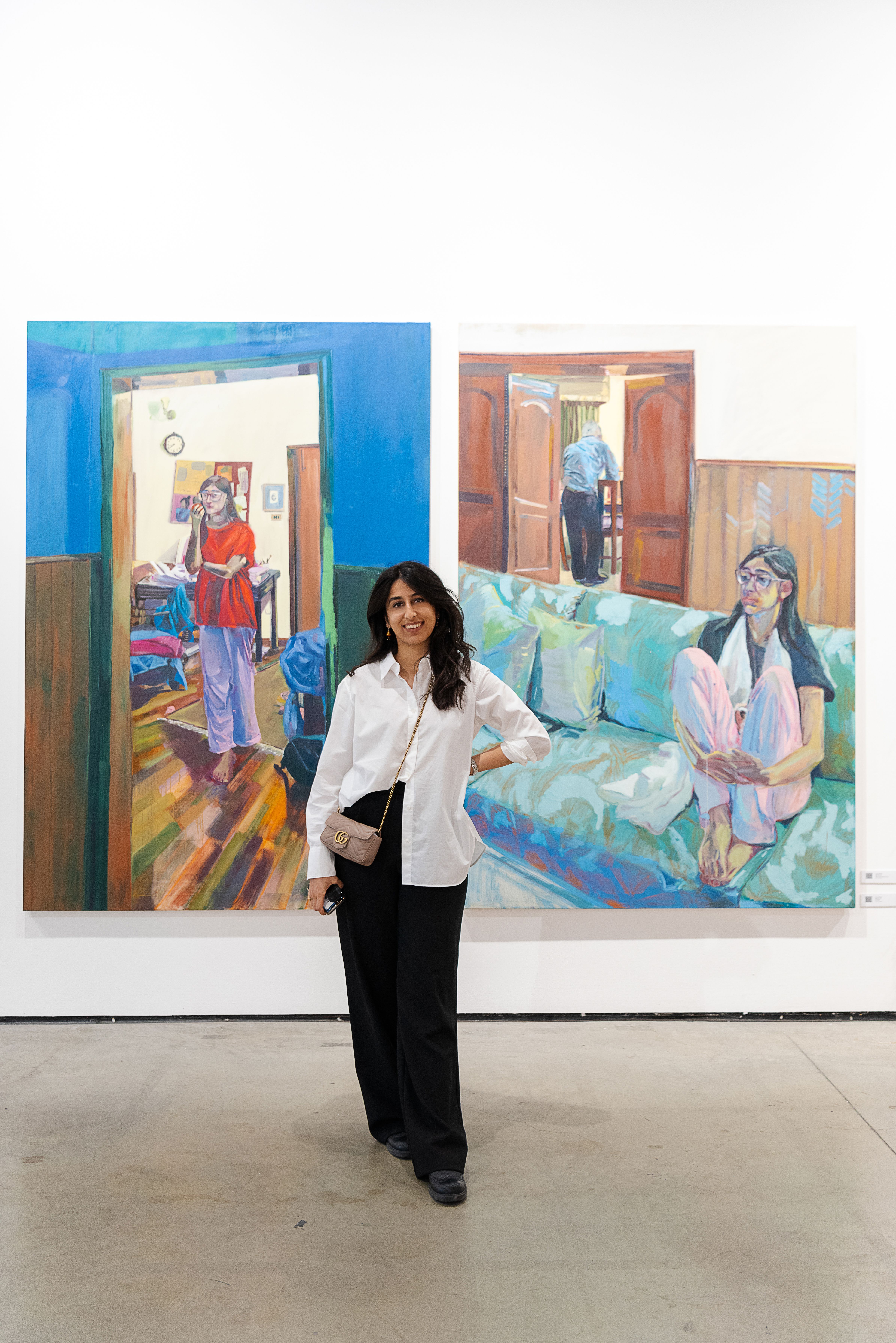 portrait of artist in front of their painting