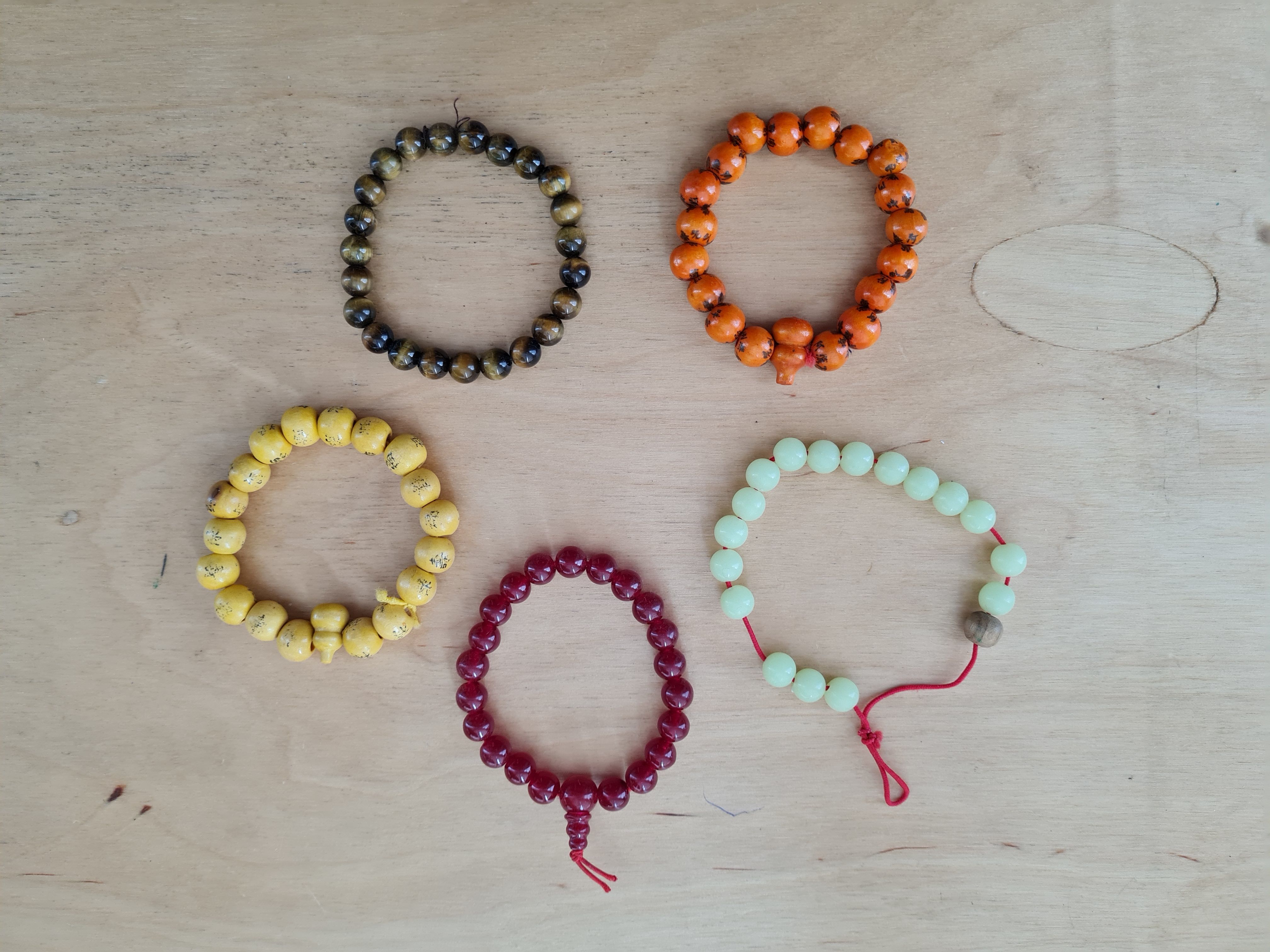 various beaded bracelets laid out on a table