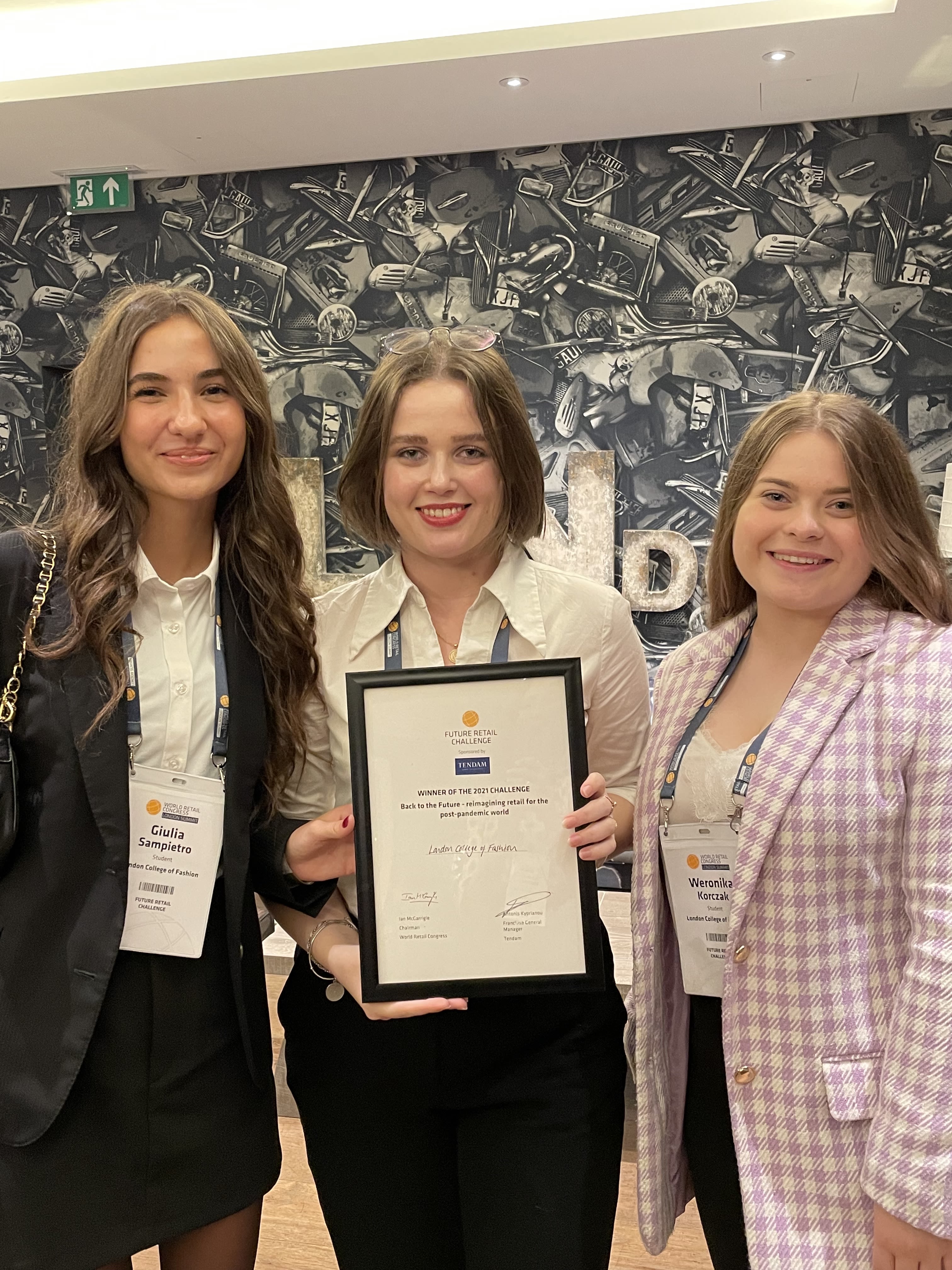 Three students holding awards 