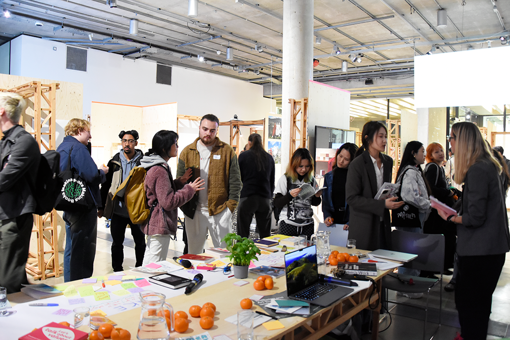 People in a gallery space socialising after an event