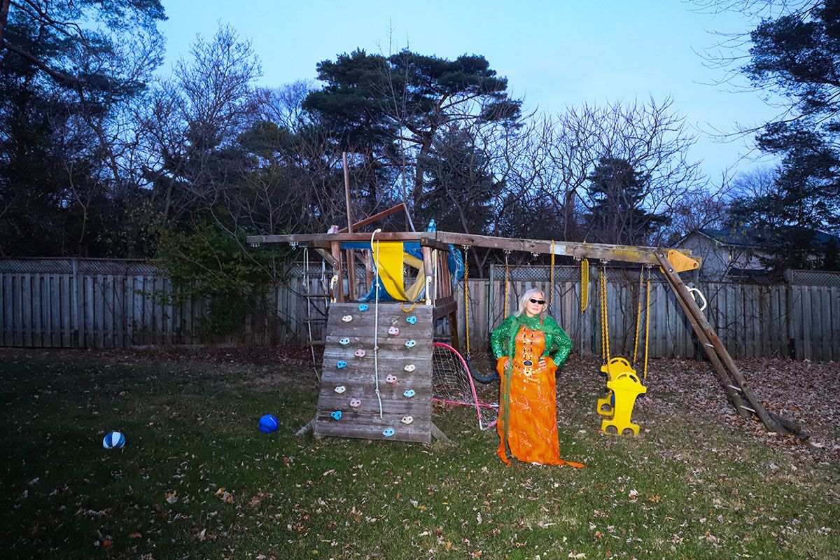 Photograph of a woman standing in a garden.