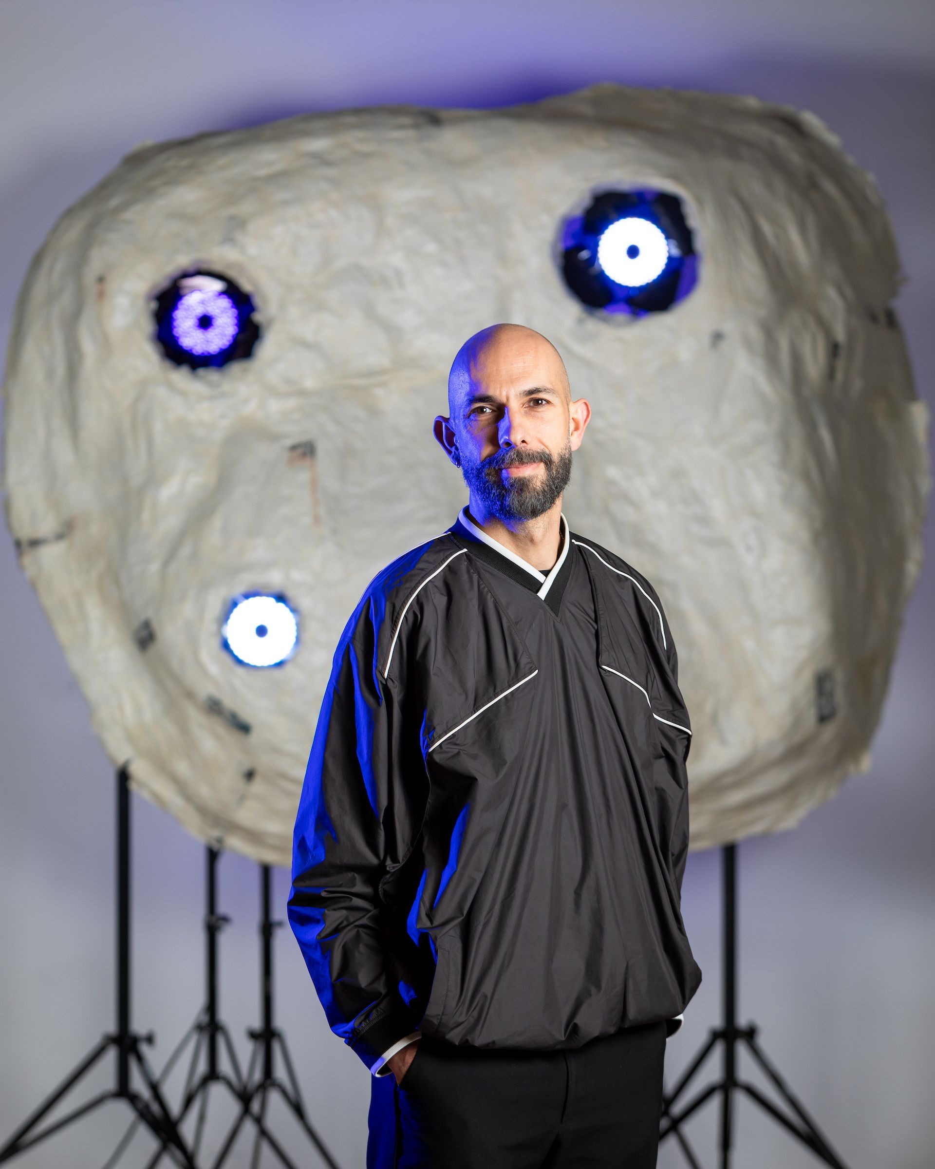 Xavi standing in front of a decorative installtion