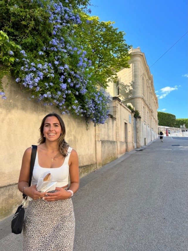 photo of girl walking in a sunny street