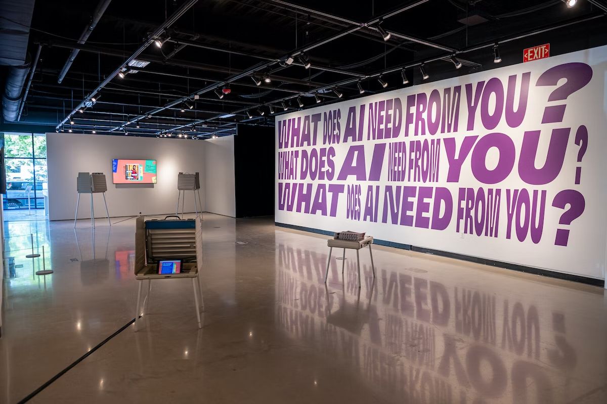 A photo of a gallery space. An exhibition on the wall reads