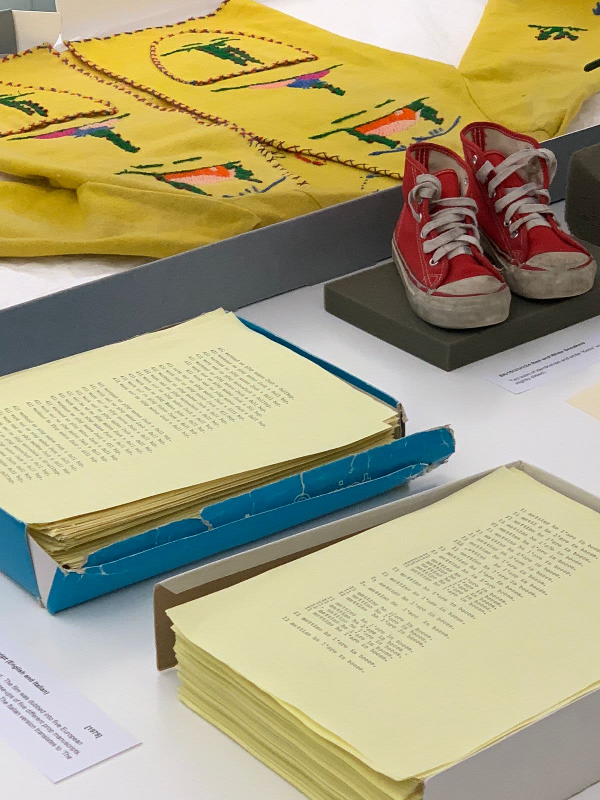 papers shoes and clothes on a table
