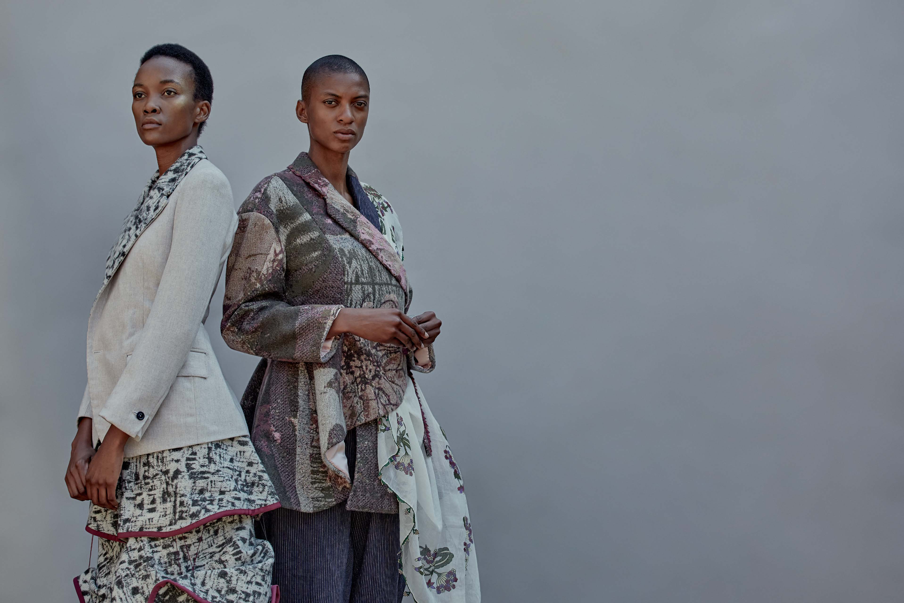 Two models wearing knitted garments