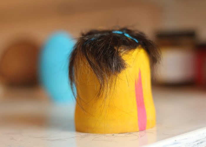 a piece of wood with hair on top