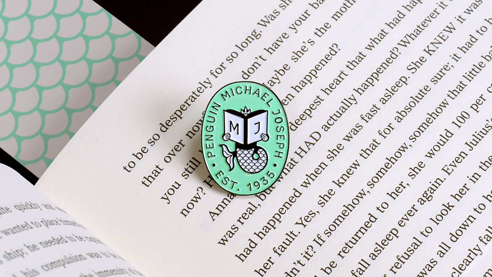 A badge sitting on a printed book.