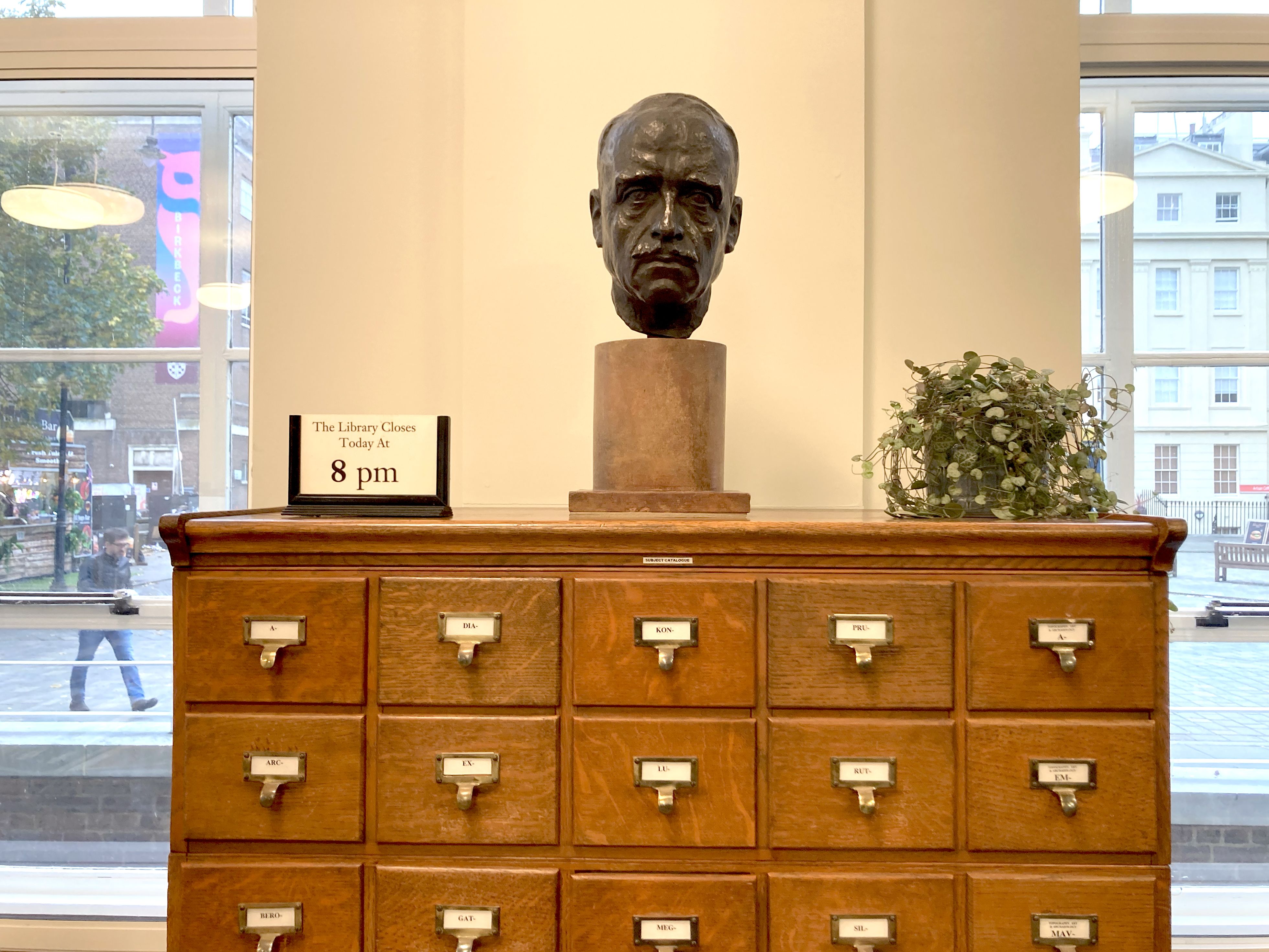 a bust of a man on top of a filing cabinet